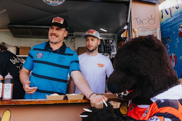 Sam Walker and Angus Crichton help promote the Food Footy and Beer Festival during the week
