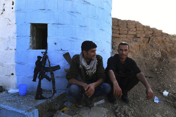 YPG militiamen Maslum Hassakeh and Zenar Zenar rest at a checkpoint 10 kilometres from the front line.