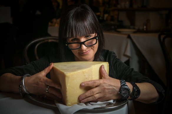 Caterina Borsato, owner of Caterina’s Cucina Bar, with a wedge of parmigiano reggiano. 