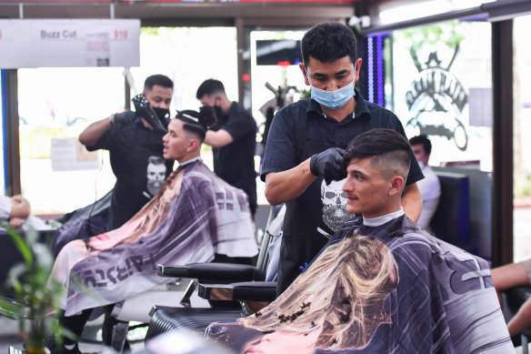 Barber Mohammad Najafi at his hair salon, Najafi Barber, in Dandenong.