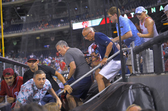 Fans rush to evacuate after hearing gunfire, during a baseball game between the San Diego Padres and the Washington Nationals at Nationals Park in Washington on Saturday July 17, 2021. The game was suspended in the sixth inning after police said there was a shooting outside the stadium. 