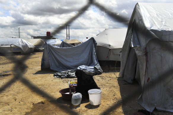 A woman washes her clothes in the al-Hawl camp in 2019.