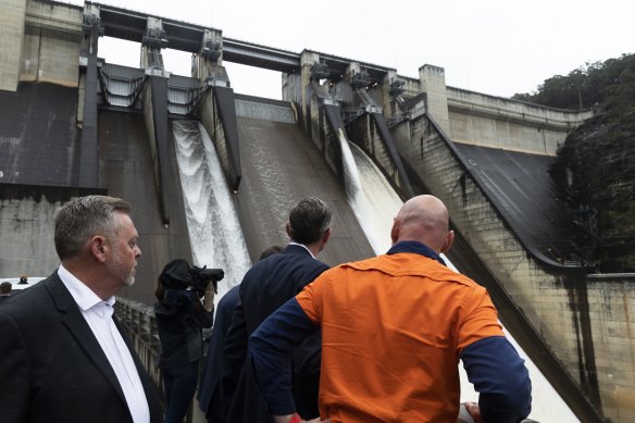 NSW Premier Dominic Perrottet (centre) inspects the Warragamba Dam on Wednesday with NSW Planning Minister Anthony Roberts (left).