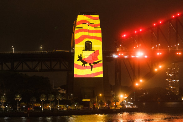 Images projected on the pylons recognise the strength of Aboriginal cultural identity through a superhero cape motif.
