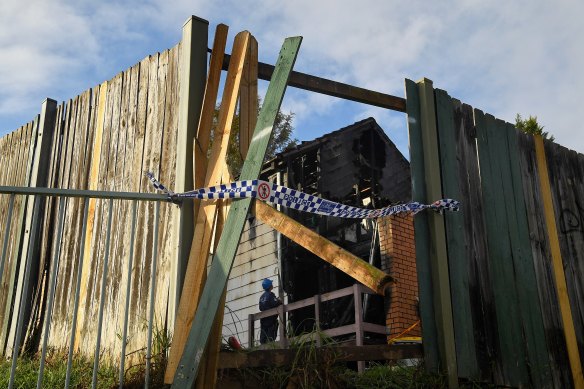 Police investigate the scene of the fatal blaze on Wednesday. 
