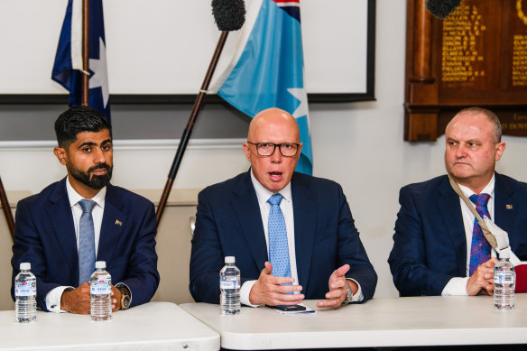 Opposition Leader Peter Dutton in Berwick in the seat of Bruce on Monday flanked by Liberal candidate Zahid Safi and MP Jason Wood.