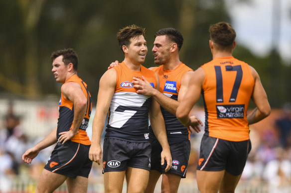 Toby Greene celebrates with Giants captain Stephen Coniglio after scoring one of his five goals against Richmond on Sunday.