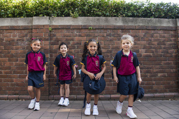 Children arrive at Marist Catholic College for the first day of school.