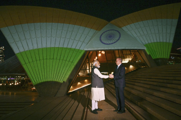 India’s Prime Minister Narendra Modi and Australian Prime Minister Anthony Albanese in front of the sails of the Sydney Opera House illuminated in the colors of the Indian flag, May 24, 2023.