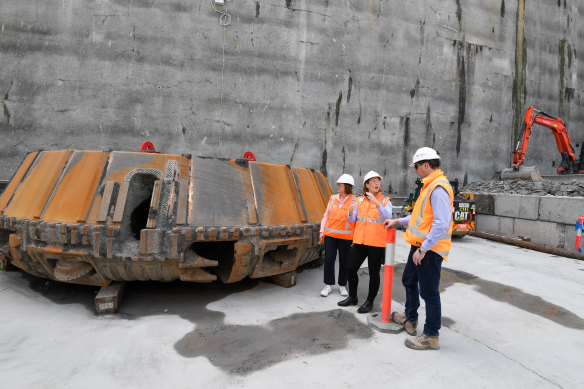 Transport Minister Jo Haylen, centre, in front of a giant cutter at Olympic Park used on one of the boring machines.