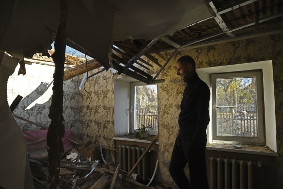 Serhiy stands inside the wreckage of his home in Novooleksandrivka.