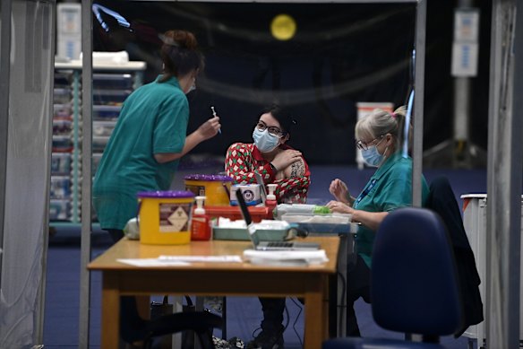 A woman is vaccinated at a mass vaccination centre on Tuesday in Belfast, Northern Ireland.