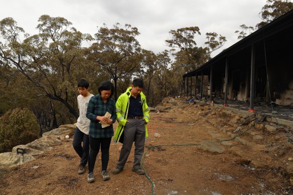 Gabriel stands with his parents Helena and Justin in the days after their Balmoral home was destroyed by the Green Wattle Creek fire in December 2019.