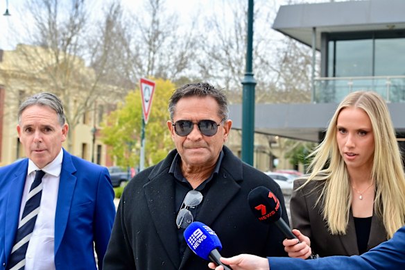 Nicky Winmar, centre, who was found guilty of assault, is pictured here with his lawyer Dermot Dann, left.
