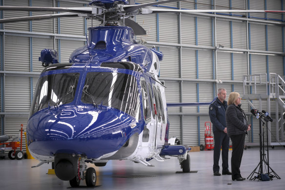 Minister for Police and Emergency Services Lisa Neville and Victoria Police air wing Inspector Craig Shepherd unveil the new police helicopter. 