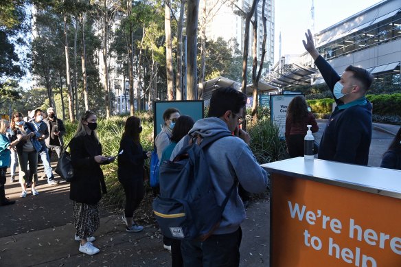 People enter the Olympic Park vaccination hub on Monday morning.