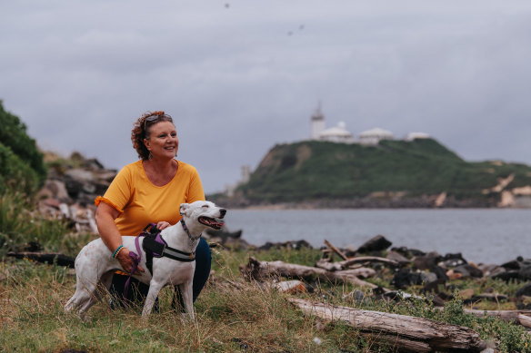 Kathleen Folbigg and her rescue dog, Snowie, at Stockton in Newcastle.