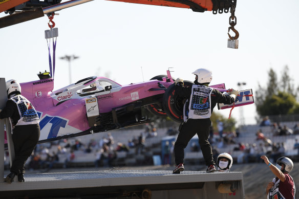 Lance Stroll's Racing Point car is hoisted after the collision with Red Bull's Max Verstappen.