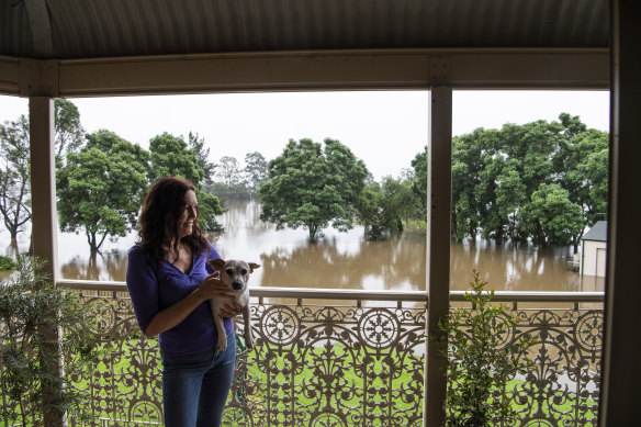 Debbie Payne looking at her home as the flood surrounding her home in Windsor.  