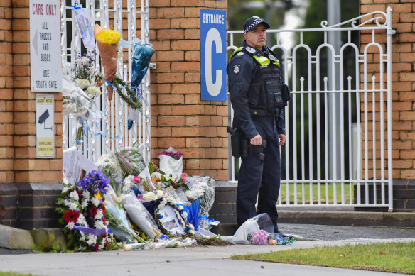 An officer stands guard outside the Victoria Police academy following the private funeral for Senior Constable Kevin King on Friday afternoon.