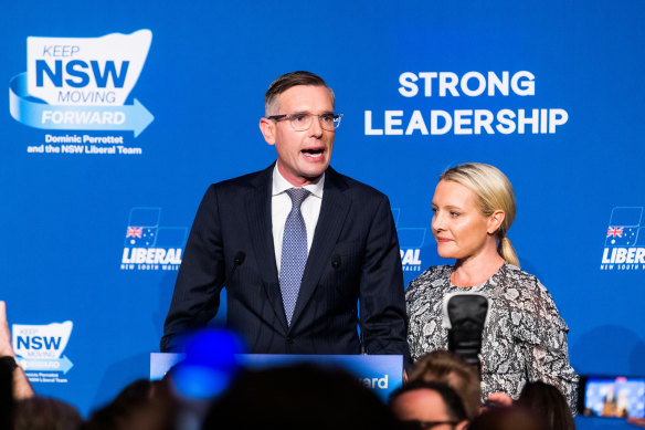 Dominic Perrottet, with wife Helen, delivers his concession speech at the Hilton in Sydney on Saturday night.