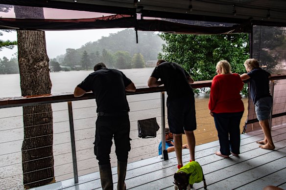 Caravan owners gather to survey the carnage on the river.