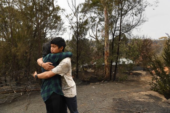 Gabriel hugs his mother, Helena, after returning to their burnt home at Balmoral. 