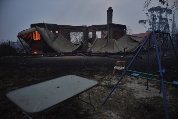 Bilpin is quiet and eerie as a southerly wind blows embers over the burnt ground.