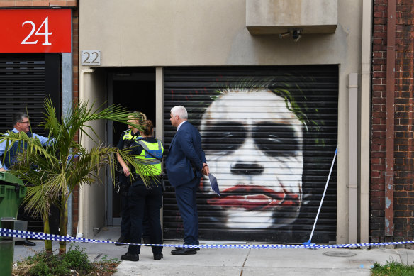 Police outside the Port Melbourne property where one of the alleged killers was arrested.