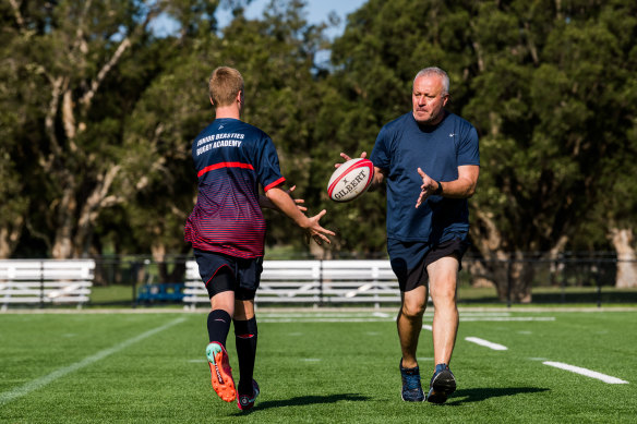 Thomas Mitsios with son Maxim at Easts Rugby training in Rose Bay on Monday.