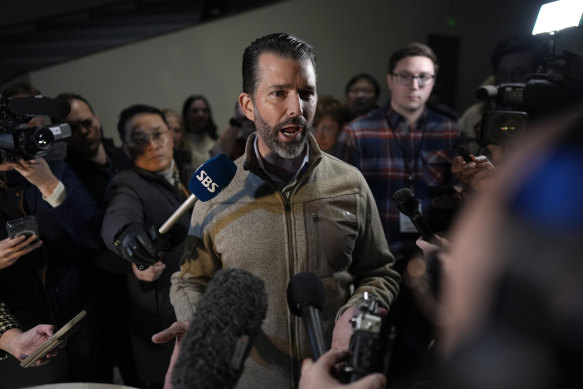 Donald Trump Jr participates in an interview as he visits a caucus site in Des Moines, Iowa.