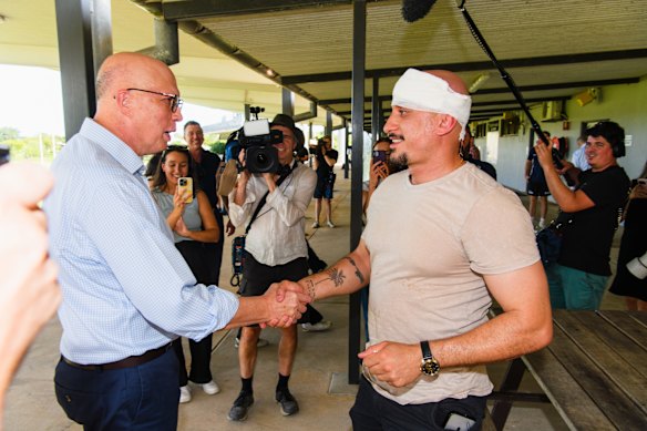 Peter Dutton checks on the injured member of the press pack.