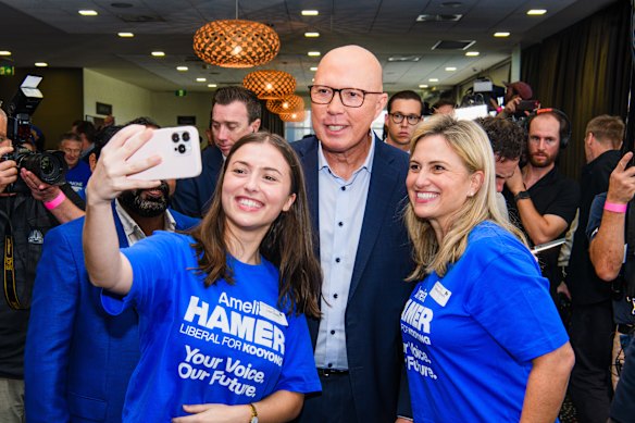 Liberal faithful pose for a selfie with  Opposition Leader Peter Dutton at a rally at the Melton Entertainment Park in Melbourne.
