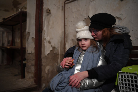 Helga Tarasova comforts her daugther Kira Shapovalova as they wait in an undergound shelter in Kyiv. 