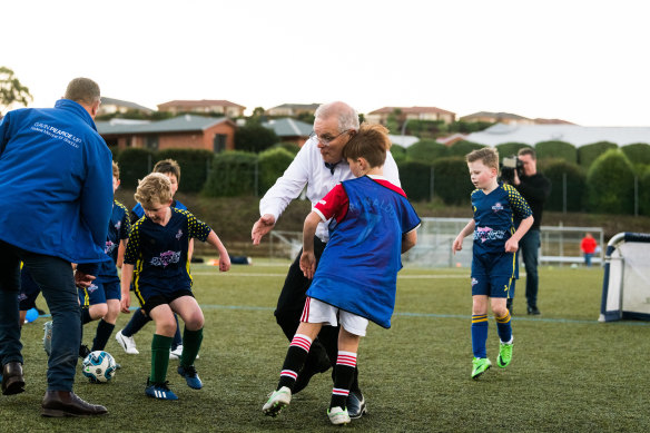 Morrison and Luca have eyes only for the ball.