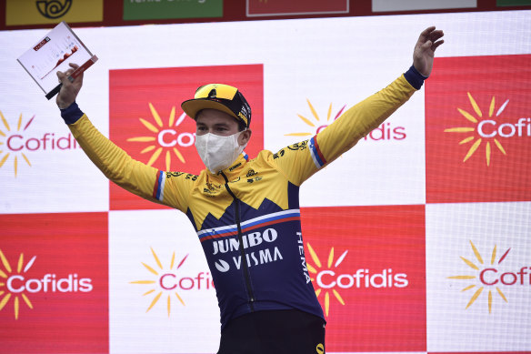 Primoz Roglic celebrates on the podium.