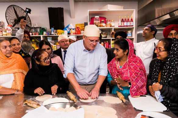 La Trobe MP Jason Wood stands behind then prime minister Scott Morrison at a visit to the Sikh community during last year’s election campaign.