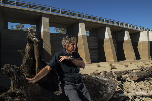 David McConnell, chairman of the Koondrook-Perricoota Alliance and a local farmer, sits in front of one of the gates of the massive 'environmental water management' project.