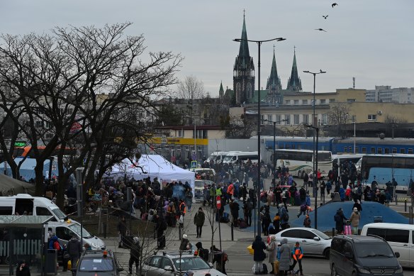 People outside Lviv railway station where trains and buses leave for Poland.