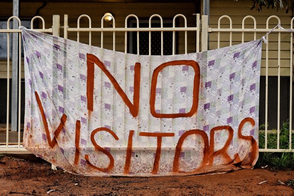 A sign hangs outside a home in Wilcannia, where 13 per cent of the local population has COVID.