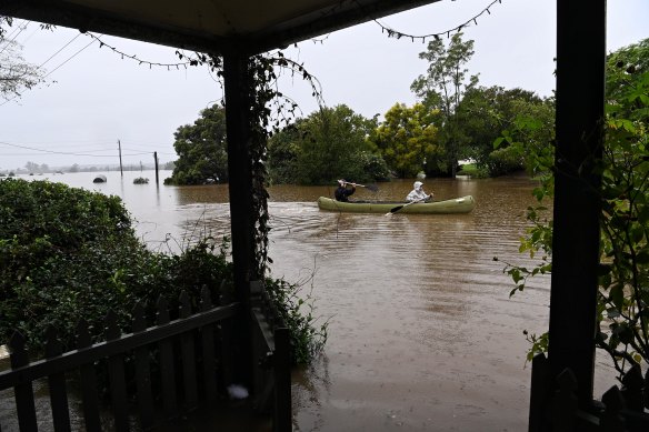 Residents check inundated homes in Windsor as the Hawkesbury River continues to rise.