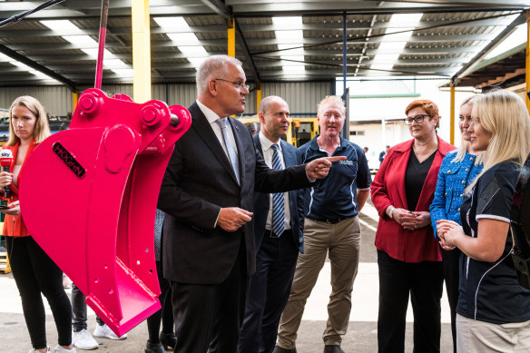 Prime Minister Scott Morrison and Treasurer Josh Frydenberg talk about a pink digger bucket being sold for charity.