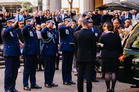 Deputy commissioners Dave Hudson, Paul Pisanos, Peter McKenna and Scott Cook salute Lay’s casket alongside Commissioner Mal Lanyon.