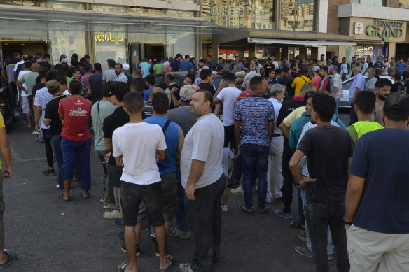 People wait in line for bread in front of a bakery in Beirut, in July. Lebanon has been without a president since October.