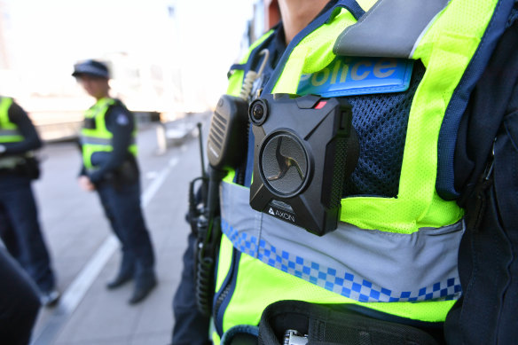 A police officer wears a body-worn camera.