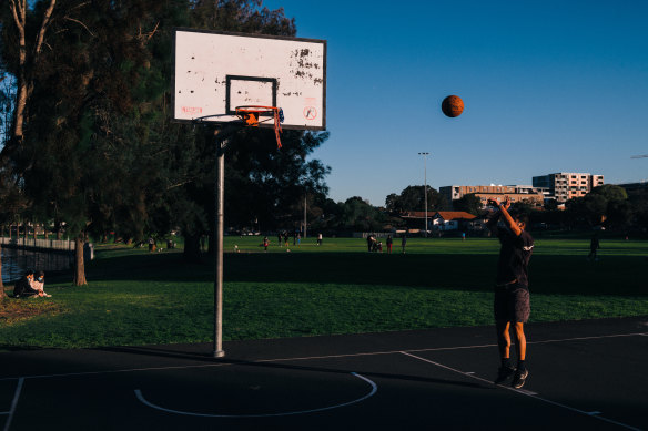 Friends took turn playing basketball in groups of two at Tasker Park in Canterbury.