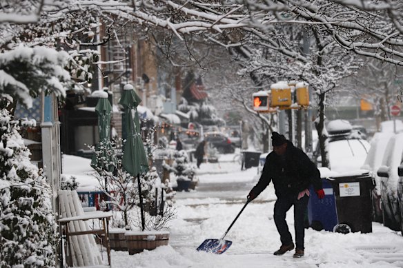 A man shovels snow in Brooklyn.