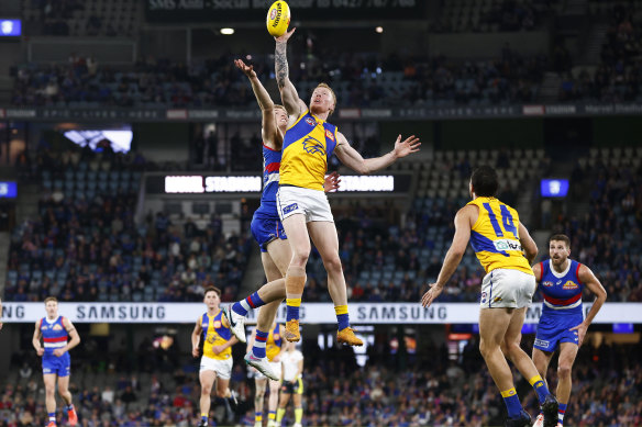 Bailey J. Williams flies high for the Eagles in the ruck against Tim English.