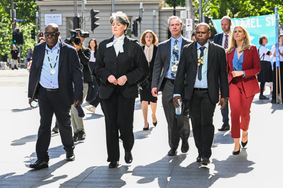 Uncle Paul Kabai (left) and Uncle Pabai Pabai (second from right) walk into the Federal Court in Melbourne.