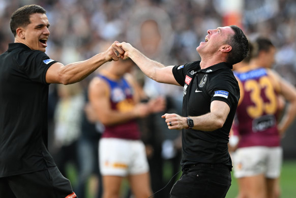 Ash Johnson (left) and Craig McRae celebrate their premiership win.